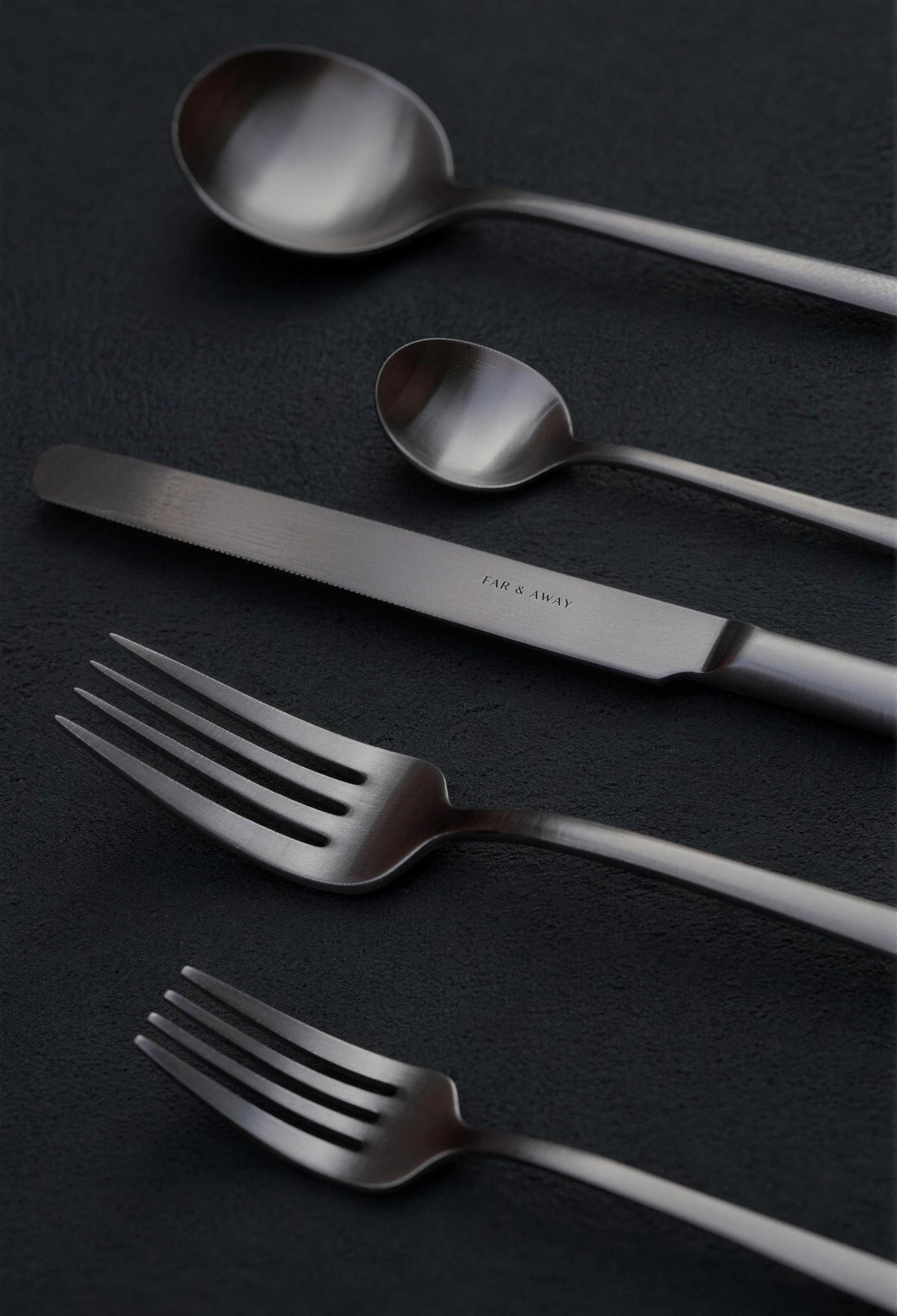 Dark cutlery set on a dark linen cloth